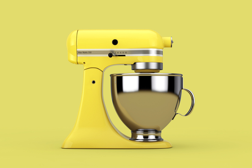 Old,Yellow,Kitchen,Stand,Food,Mixer,On,A,Yellow,Background.
