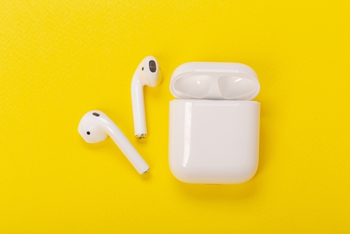 White,Wireless,Headphones,With,Charging,Case,On,Yellow,Background